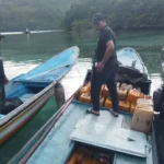 Petugas berada di perahu yang mengangkut solat bersubsidi yang akan dikirim ke Maluku Utara di Banggai Laut. (Foto: Dipolairu Polda Sulteng)