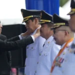 Gubernru Sulteng Anwar Hafid menyematkan tanda jabatan Bupati dan Wakil Bupati pada pelantikan dan pengambilan sumpah Bupati dan Wakil Bupati Kabupaten parigi Moutong dan Banggai hasil PSU Pilkada 2024 di Lapangan Pogombo, Palu, Senin (2/6/2025). (bmzIMAGES/Basri Marzuki)