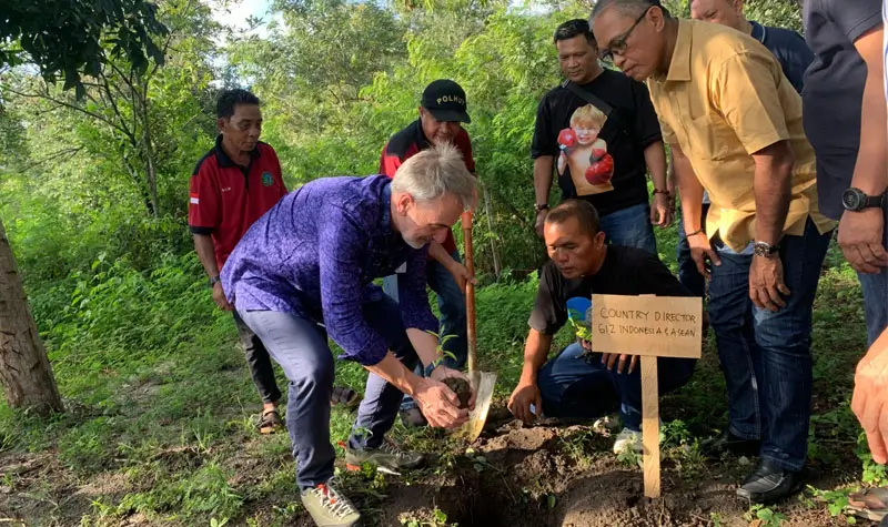 Country Director GIZ Indonesia, Hans Ludwig Bruns menanam pohon cendana menandai dimulainya pembangunan Arboretum di Taman Hutan Raya (Tahura) Kapopo, Senin (9/6/2025). (Foto: ROA Sulteng)